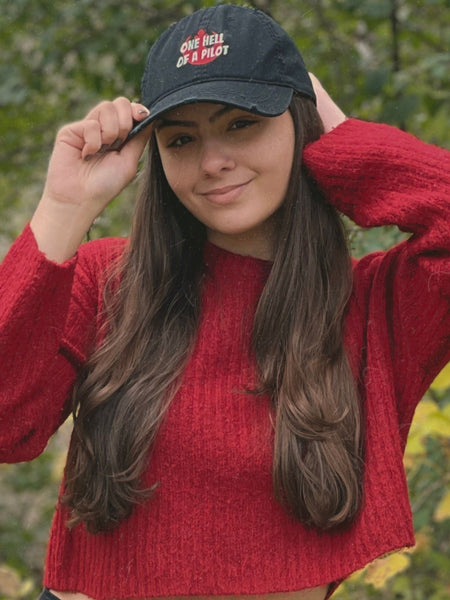 Poe Dameron Hat One Hell of a Pilot Star Wars Baseball Cap Headwear Accessories Oscar Isaac Finn John Boyega Outfit Cosplay Galaxy's Edge Disneyland Disney World Hollywood Studios Gift Trip Black Red Orange Gray Embroidery Distressed Vintage Woman wearing Hat with Red Sweater Smiling Long Brown Hair