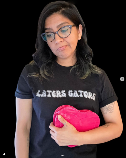 Laters Gators Moon Knight Shirt steven grant mr knight oscar isaac avengers campus disneyland marvel comic con meet and greet character outfit cosplay costume tshirt graphic tee unisex men women Woman holding Pink Chocolate Hearts Candy Box wearing glasses