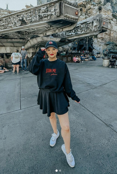 Kylo Ren Sweatshirt join me please the last jedi Star Wars sweater shirt unisex cotton polyester men women cosplay costume reylo rey adam driver ben solo disneyland disneyworld galaxy's edge batuu star wars nite event comic con adam driver daisy ridley rian johnson Woman wearing skirt and Join Me Please Embroidered Sweater and One Hell of a Pilot Hat in front of the millennium falcon smugglers run ride at galaxys edge batuu orlando florida with white sneakers and black skirt