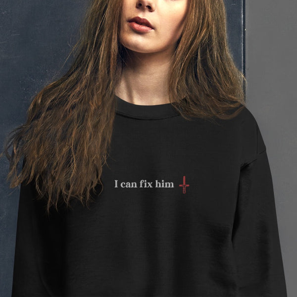 Woman wearing I Can Fix Him with red kylo ren lightsaber embroidered black sweatshirt. For Star Wars fans of sequels trilogy. Adam Driver.
