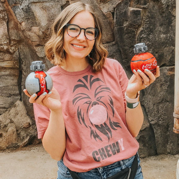 Chewbacca Bubblegum Shirt, chewy bubble trouble tee, for Wookiee Han Solo Star Wars trilogy fans. Pilot the millennium falcon on Smuggler's Run at disneyland California Hollywood Studios Orlando Florida Galaxy's Edge. Wear with your Batuu bound outfit. Unisex comfy fit, size inclusive XS-4XL. Worldwide shipping. Diet Coke and Coca-Cola from Galaxy's Edge girl with glasses.