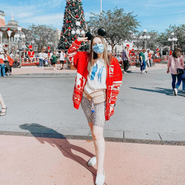 Mask wearing woman wearing Chewie We're Home Shirt Disney Parks graphic tee Disneyland Disney WORLD Chewbacca holding a Mickey balloon with red heart and Han Solo wearing Mickey ears holding a blaster Neon 90's effect design font