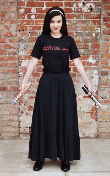 Woman wearing Kylo Ren Rey Quote the girl i've heard so much about Star Wars The Force Awakens sequels trilogy reylo top shirt graphic tee unisex cotton women costume cosplay lightsaber jedi villain darkside helmet darth vader convention. Holding rey and princess leia lightsabers