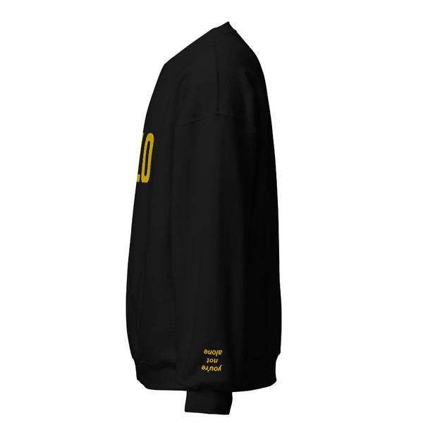 Embroidered sweatshirt that says REYLO on the front and you're not alone on the left sleeve. For Star Wars fans of Kylo Ren, Ben Solo and Rey. Shown in black with yellow embroidery.