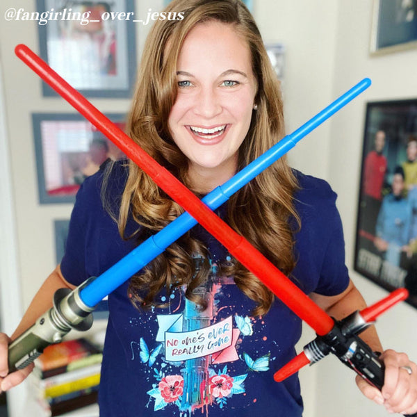 Kylo Ren Ben Solo Lightsaber Shirt Graphic Tee No One's Ever Really Gone Star Wars Sequels Novelization Quote Blue Butterfly Rey Nobody Skywalker Tattoo Graffiti Men Women Unisex Galaxy's Edge Disneyland Disney World Comic Con Cosplay Adam Driver Woman holding 2 lightsabers red blue hilt cosplay