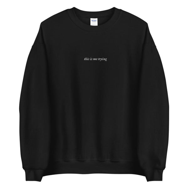 Embroidered sweatshirt in black that says this is me trying from folklore taylor swift music album music lyrics quote. White embroidery on black fabric. Long sleeve pullover sweater.