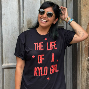 Woman wearing The Force Is Female Shirt by Shop Friday Apparel holding Ahsoka Tano Lightsabers wearing a mask at Galaxy's Edge Batuu at Walt Disney World in Florida cosplay as a Jedi