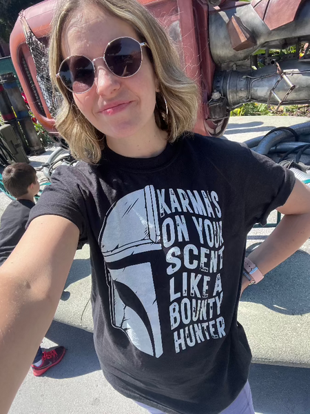 Karmas on your scent like a bounty hunter shirt disney swiftie star wars taylor swift eras tour midnights the mandalorian baby yoda grogu t-shirt graphic tee outfit disneyland disney world hollywood studios galaxy's edge batuu woman at galaxy's edge downtown disney star trader store rey skywalker ship tatooine jakuu