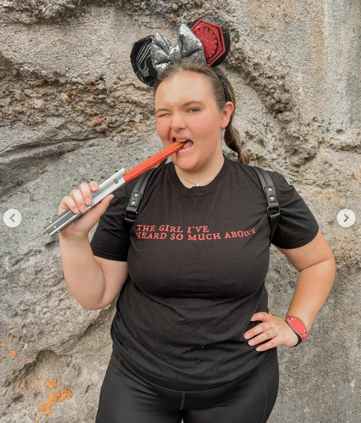 Girl wearing Kylo Ren Rey Quote the girl i've heard so much about Star Wars The Force Awakens sequels trilogy reylo top shirt graphic tee unisex cotton women costume cosplay lightsaber jedi villain darkside helmet darth vader convention at Walt Disney World Hollywood Studios wearing kylo ren star wars mickey ears eating a lightsaber churro food snack