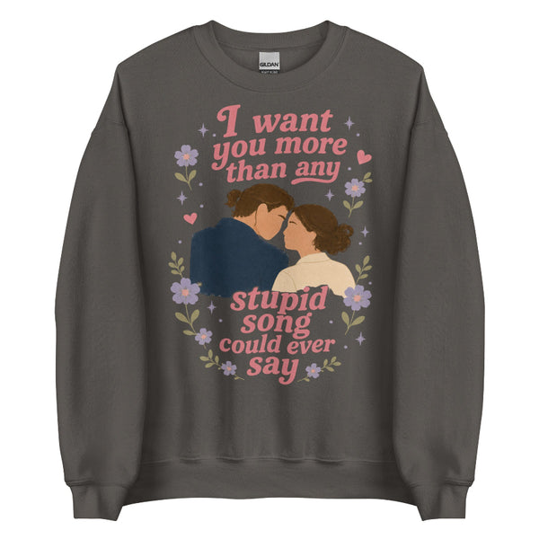 Charcoal gray unisex sweatshirt featuring Anakin and Padmé with floral artwork and the quote "I want you more than any stupid song could ever say," inspired by Olivia Rodrigo and Star Wars. Romantic fandom sweatshirt for Disney fans.
