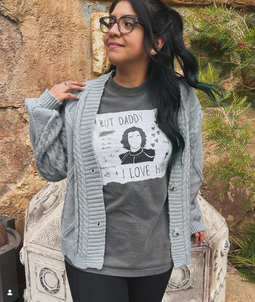 Woman at Galaxy's Edge Batuu Disneyland Theme Park wearing But Daddy I Love Him Kylo Ren Comfort Colors Shirt in grey with black and white design and Star Wars mickey ears with black skirt and tattoos