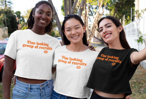 White and black cropped graphic t-shirt with distressed orange “Fine Looking Group of Recruits” lettering and small kiss graphic.