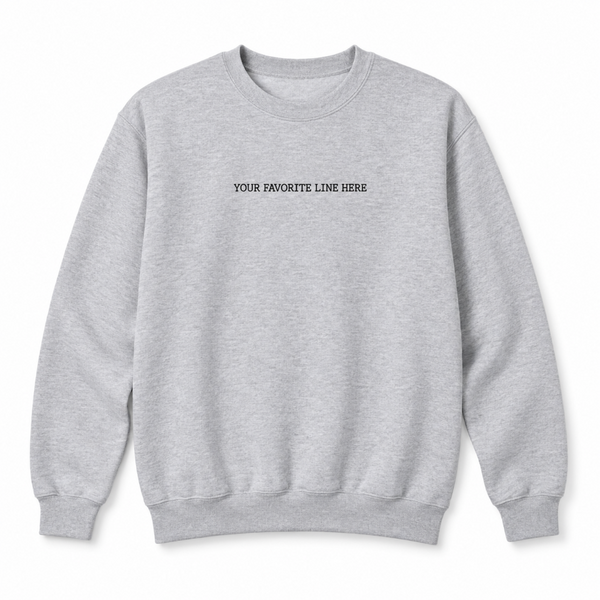 Unisex crewneck sweatshirt with a small romance book quote embroidered across the center chest.