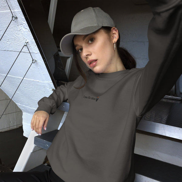 Dark gray unisex embroidered sweatshirt featuring the phrase "I can fix him" stitched in small black lettering on the left chest. Minimalist fantasy-inspired embroidered crewneck for Lord of the Rings fans.