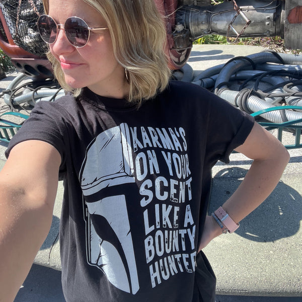 Karmas on your scent like a bounty hunter shirt disney swiftie star wars taylor swift eras tour midnights the mandalorian baby yoda grogu t-shirt graphic tee outfit disneyland disney world hollywood studios galaxy's edge batuu woman at galaxy's edge downtown disney star trader store rey skywalker ship tatooine jakuu