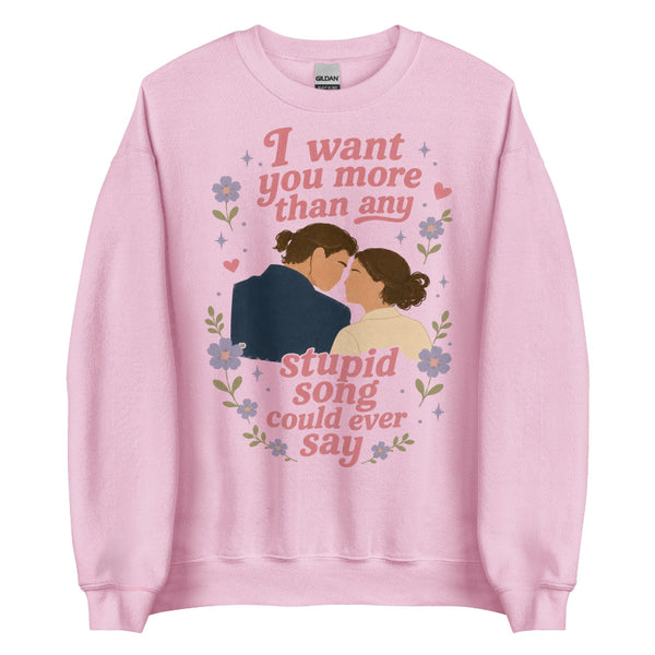 Pink unisex sweatshirt featuring Anakin and Padmé with floral artwork and the quote "I want you more than any stupid song could ever say," inspired by Olivia Rodrigo and Star Wars. Romantic fandom sweatshirt for Disney fans.