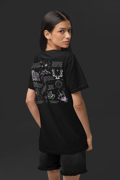 Woman wearing Rhysand High Lord Shirt on Black Comfort Colors with purple design. Front design says Rhysand High Lord of the Night Court. Back design has ACOTAR inspired references. Bat boys wings sword book reading faerie outfit.