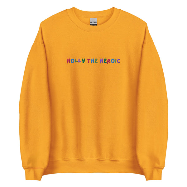 Mustard yellow unisex embroidered sweatshirt with colorful stitched text reading ‘Holly the Heroic,’ Stranger Things inspired Holly Wheeler fan design.
