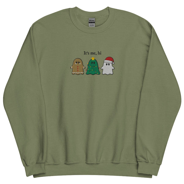 “It’s Me, Hi” embroidered Christmas sweatshirt showing three festive ghost characters—a gingerbread ghost, a Christmas-tree ghost with lights, and a Santa ghost—stitched on a sage green unisex crewneck. Taylor Swift swift midnights anti hero music lyrics holiday gift