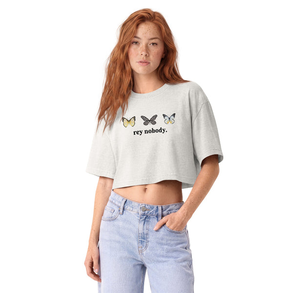 Woman wearing a vintage garment-dyed cropped tee featuring a Rey Nobody inspired design. Relaxed washed Bella + Canvas cropped t-shirt for Rey fans, sequel trilogy lovers, Galaxy's Edge outfits, and subtle fandom fashion.