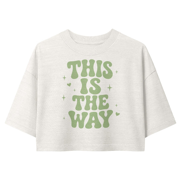 Woman wearing a vintage garment-dyed cropped tee featuring the phrase "This Is The Way." Relaxed washed Bella + Canvas cropped t-shirt for Galaxy's Edge outfits, Batuu adventures, meeting Mando, and subtle fandom fashion.
