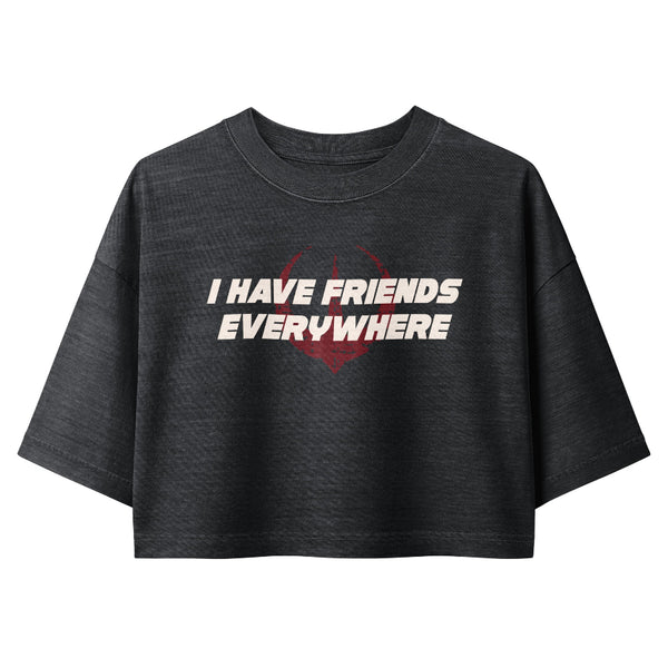 Woman wearing a vintage garment-dyed cropped tee featuring the phrase "I Have Friends Everywhere." Relaxed washed Bella + Canvas cropped t-shirt inspired by Andor, the Rebel Alliance, Galaxy's Edge outfits, and subtle fandom fashion.