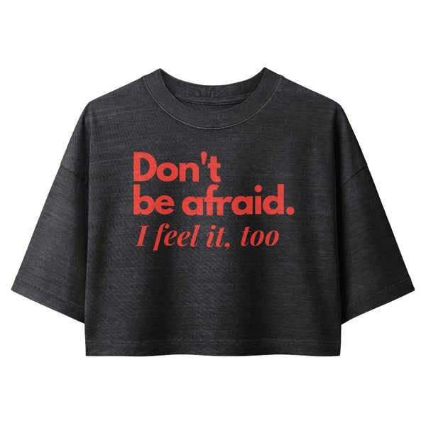 Woman wearing a vintage garment-dyed cropped tee featuring a Don't Be Afraid inspired design. Relaxed washed Bella + Canvas cropped t-shirt for Kylo Ren fans, Reylo readers, Galaxy's Edge outfits, and subtle fandom fashion.