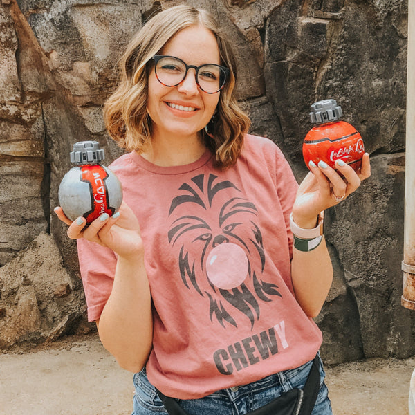 Chewbacca Bubblegum Shirt, chewy bubble trouble tee, for Wookiee Han Solo Star Wars trilogy fans. Pilot the millennium falcon on Smuggler's Run at disneyland California Hollywood Studios Orlando Florida Galaxy's Edge. Wear with your Batuu bound outfit. Unisex comfy fit, size inclusive XS-4XL. Worldwide shipping. Diet Coke and Coca-Cola from Galaxy's Edge girl with glasses.